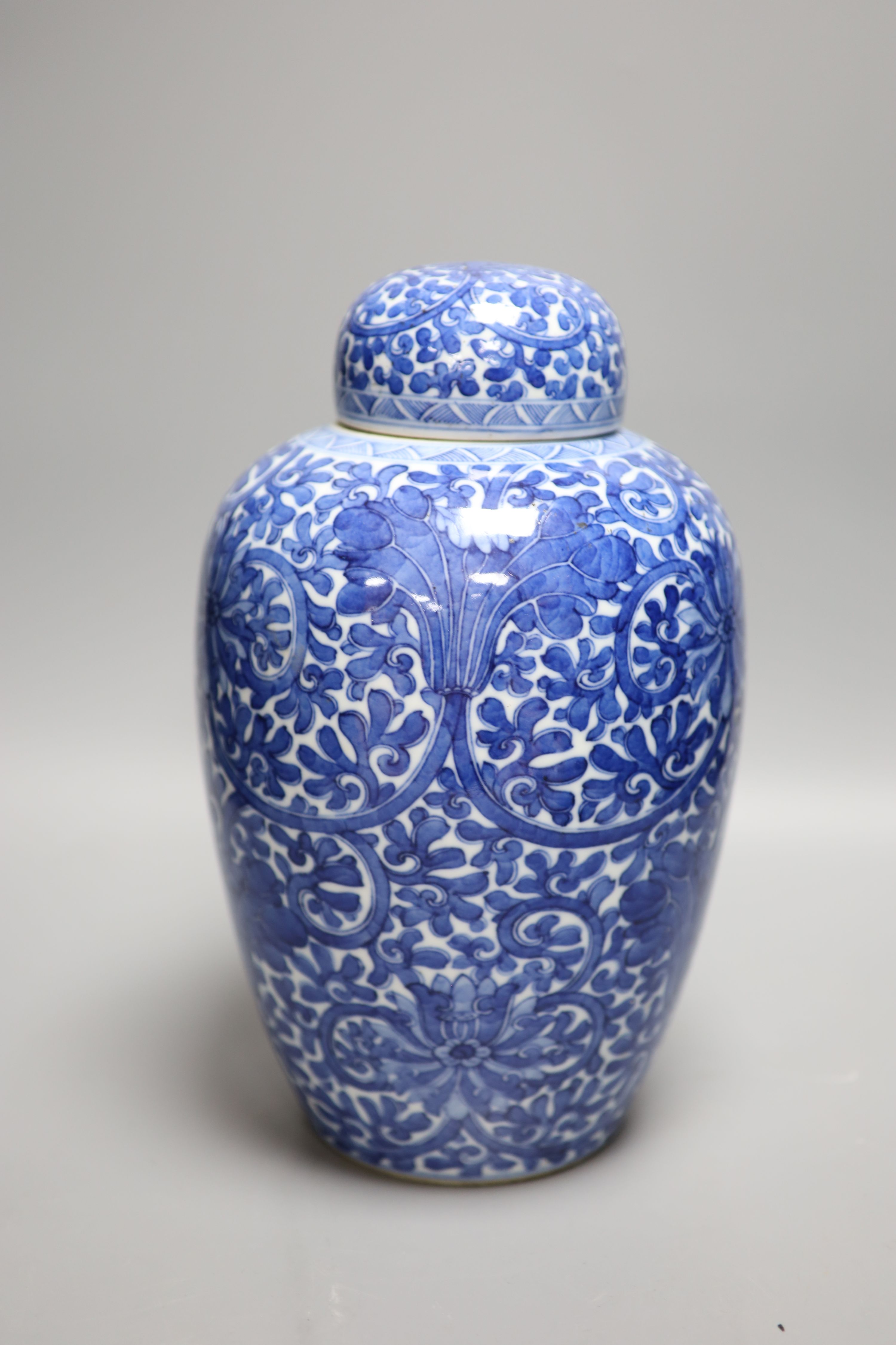 A Chinese blue and white lotus jar and cover, early 20th century, a similar dragon vase and a small Kangxi jarlet and cover, talles